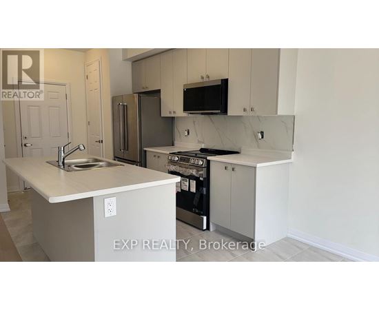 A kitchen with a sink, stove, and refrigerator.