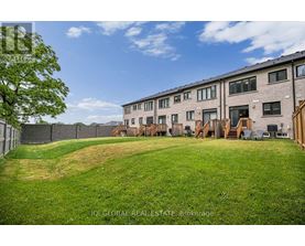 A grassy area in front of apartment buildings.