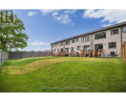 A grassy area in front of apartment buildings.