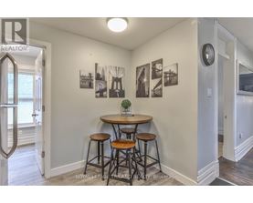 A small dining area with a table and chairs.