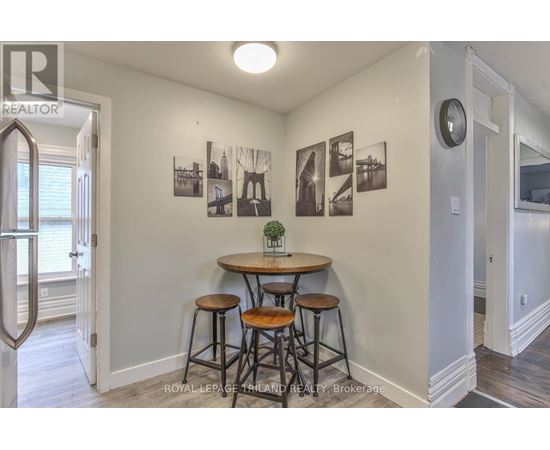 A small dining area with a table and chairs.