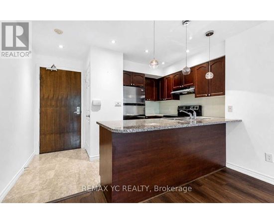 A kitchen with a wooden island and a refrigerator.