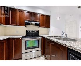 A kitchen with a stove top oven and a sink.