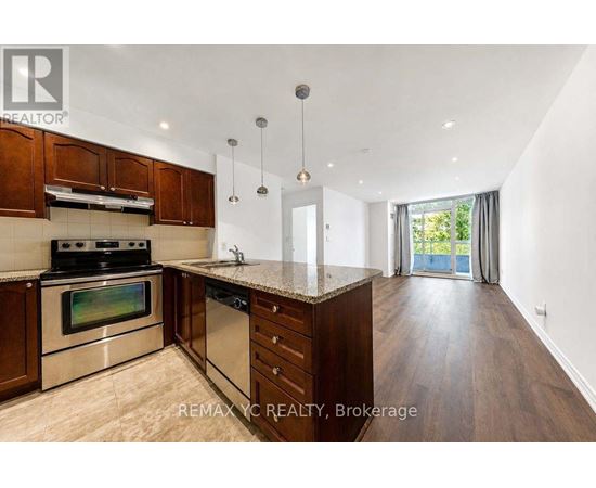 A modern kitchen with wooden cabinets and stainless steel appliances.