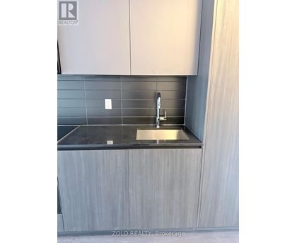 A modern kitchen with a sink and cabinets.