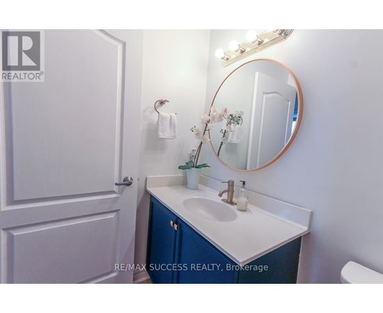 A bathroom with a sink, mirror, and towel.