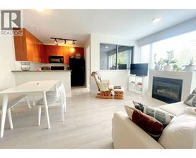 A modern living room with a fireplace and a dining table.