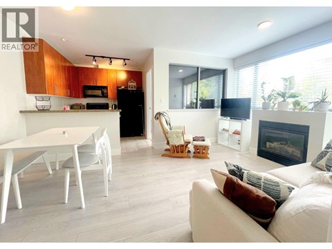 A modern living room with a fireplace and a dining table.