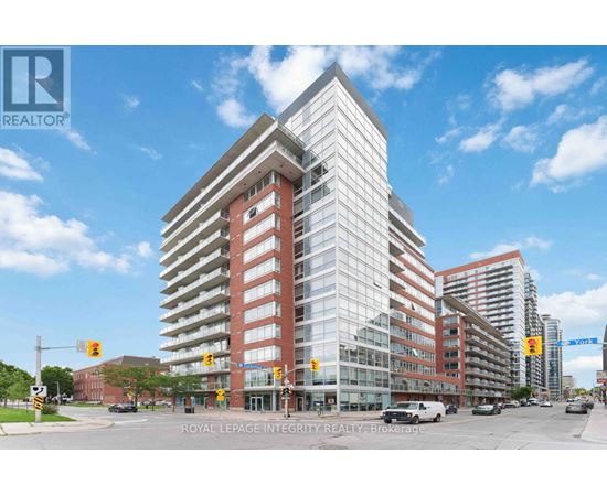 A large, modern building with a glass facade is the focal point of the image.