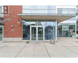 The image shows the front of a building with a glass door and windows.