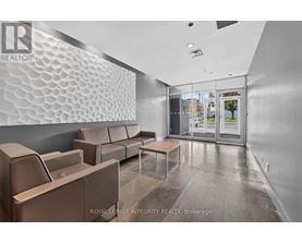 A waiting area with a glass wall and a patterned wall.