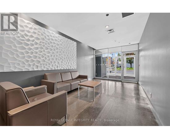 A waiting area with a glass wall and a patterned wall.