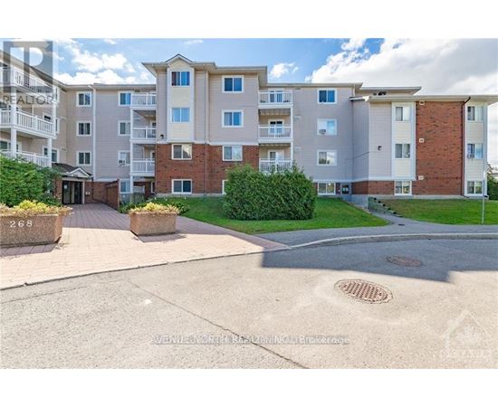 A large apartment complex with a driveway in front.