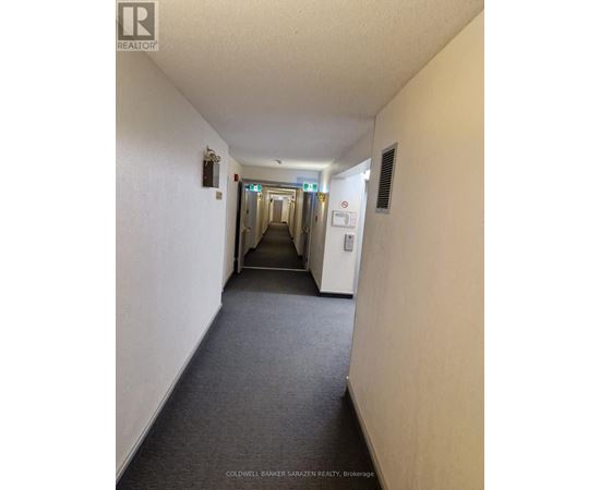 A realtor image of a bedroom with a mirror and a door.