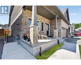 A house with a stone facade and a covered patio.