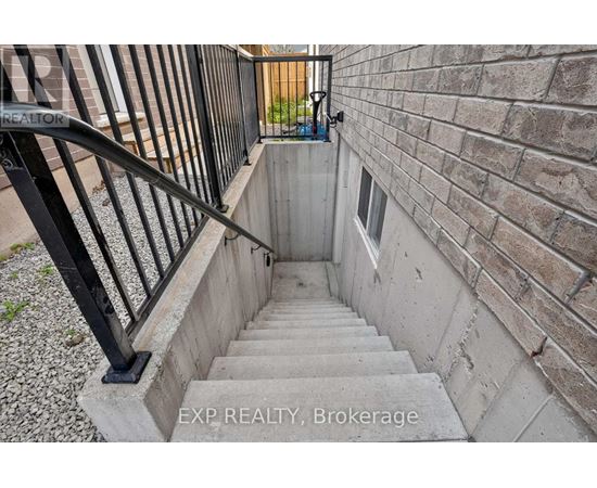 A staircase with a black railing leads up to a door.