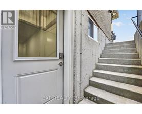 A set of stairs leading up to a door with a glass window.
