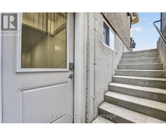 A set of stairs leading up to a door with a glass window.