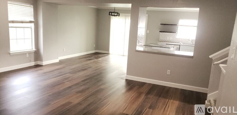 A room with wood flooring and a mirror on the wall.