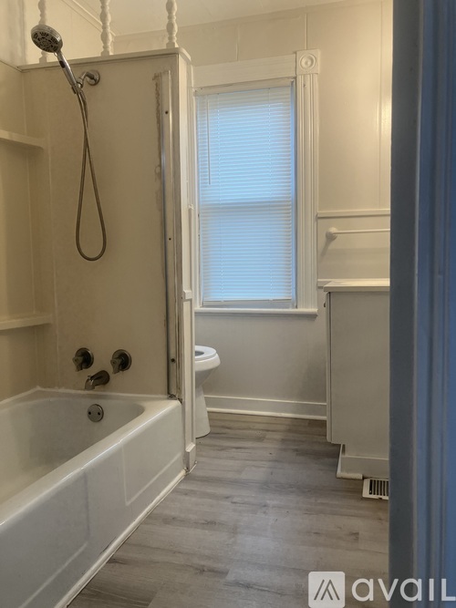 A white toilet with a tank and a cabinet above it.