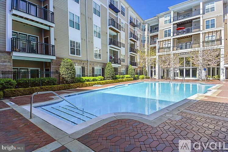 A swimming pool in a residential area surrounded by buildings.