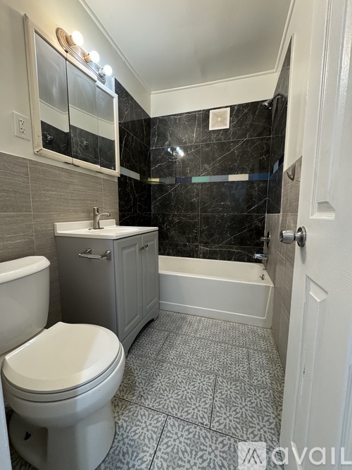 A bathroom with a toilet, sink, and bathtub.