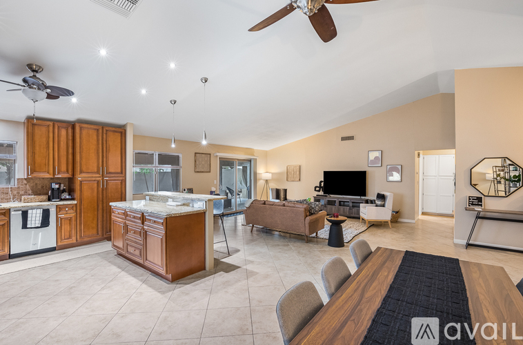A spacious kitchen and living room with a dining table and chairs.