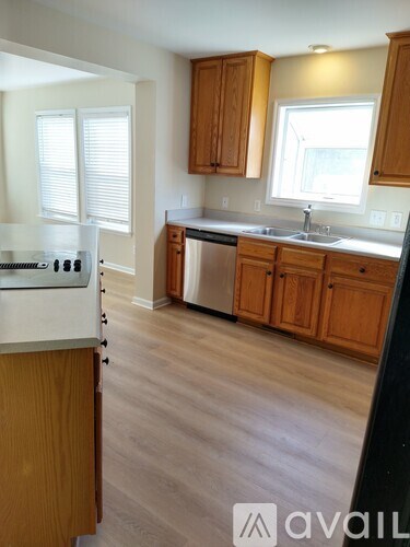 A kitchen with wooden cabinets and a white countertop.