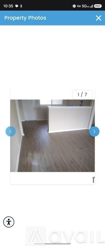A room with a wooden floor and white walls.