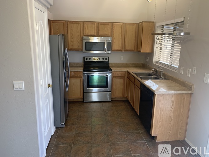 A kitchen with a stove top oven and a refrigerator.