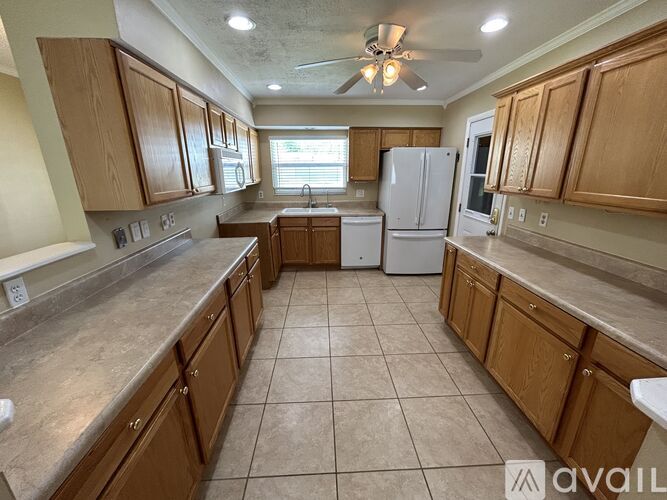 A kitchen with wooden cabinets and a white refrigerator.