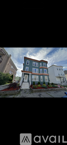 A two-story house with a blue and white exterior is for sale.