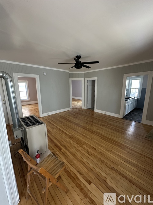 A room with wooden floors and a ceiling fan.
