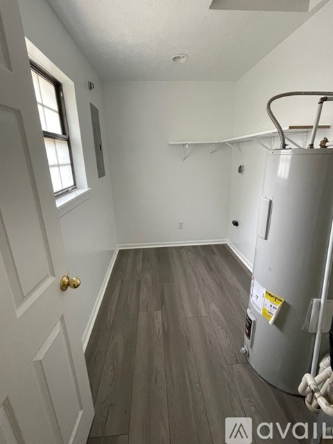 A kitchen with a white door and a white fridge.