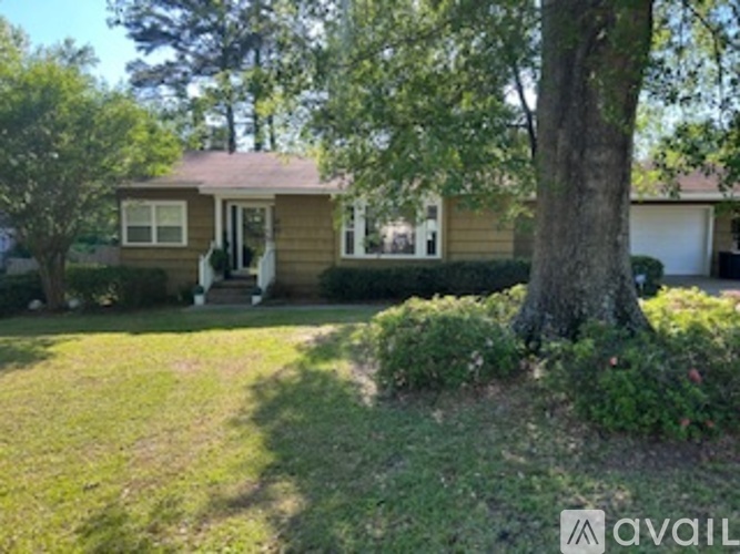 A house with a tree in front of it.