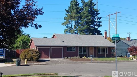 A house with a red roof and a sign that says "available" in front of it.