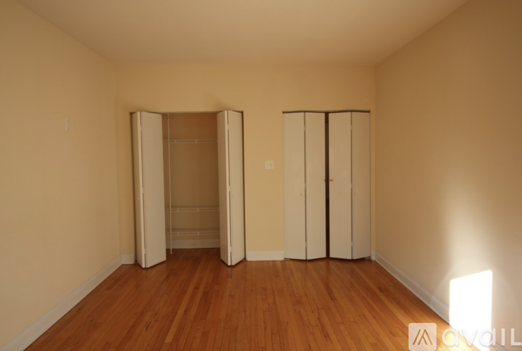A room with a wooden floor and a white door.