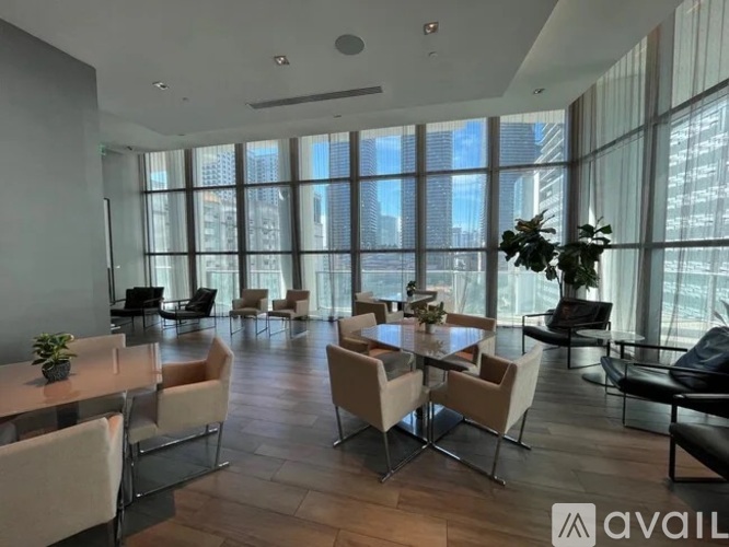 A modern dining room with a large table and chairs.