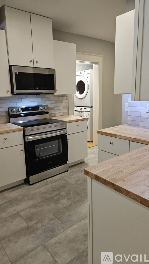 A modern kitchen with a stove top oven and microwave.