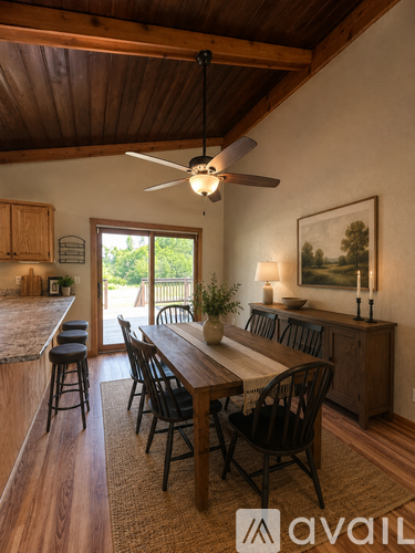 A dining room with a wooden table and chairs.