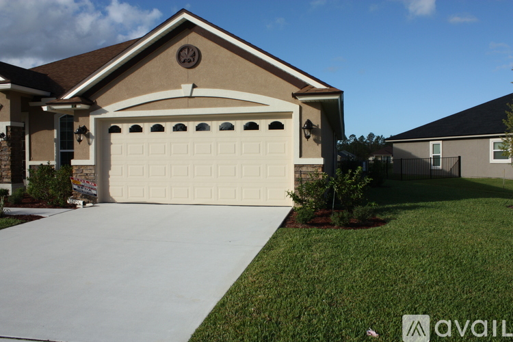 A house with a garage door and a driveway.
