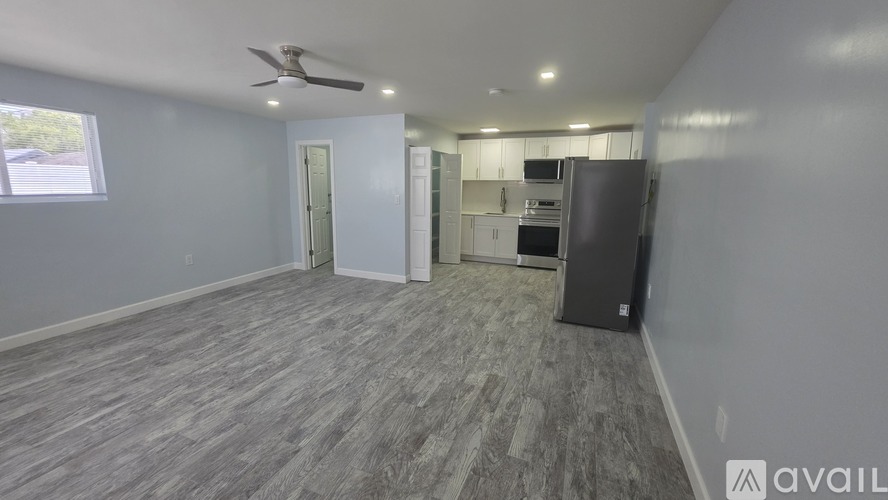A kitchen area with a refrigerator, oven, and microwave.