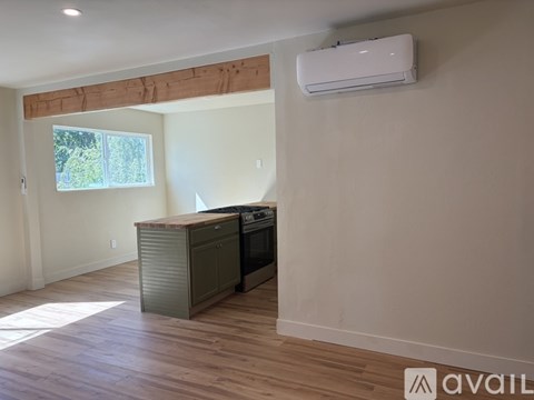 A kitchen area with a stove and cabinets.