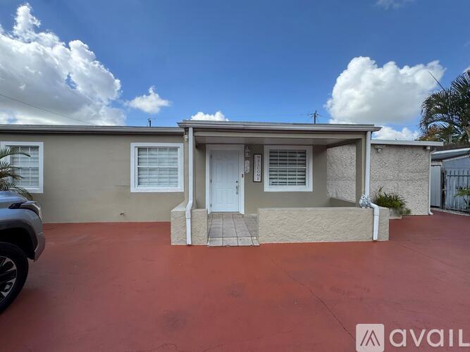 A house with a red floor and a white door is available for rent.