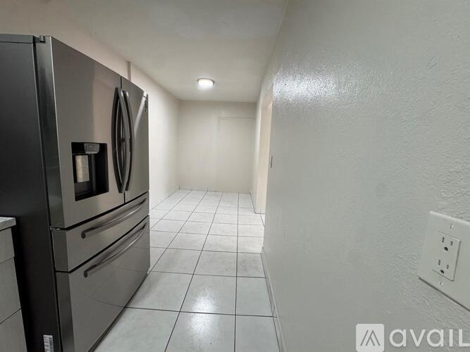 A kitchen with a stainless steel refrigerator and oven.