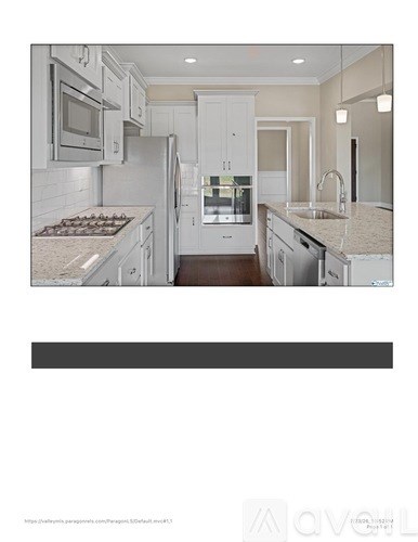 A modern kitchen with white cabinets and appliances.