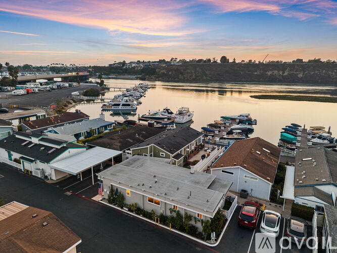 A marina with boats docked in the water and buildings surrounding it.