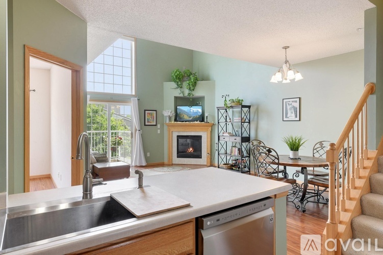 A kitchen with a sink, stove, and dishwasher.