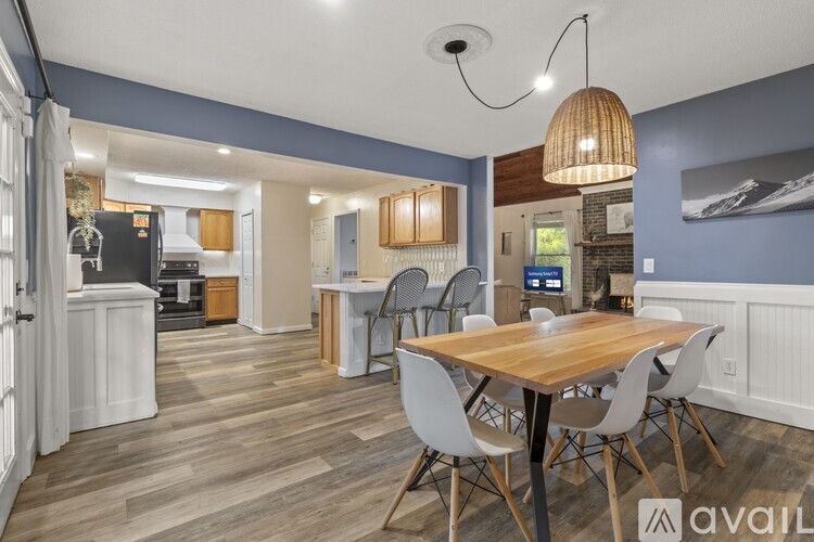 A kitchen with a dining table and chairs.
