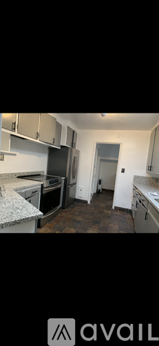 A kitchen with granite countertops and stainless steel appliances.
